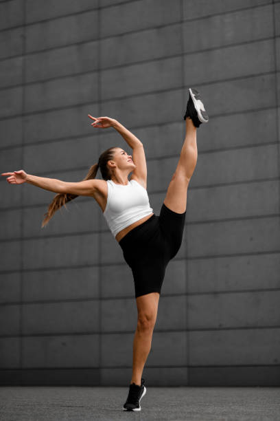 istock Unique urban flexibility. Girl stretching prowess. 2053174564