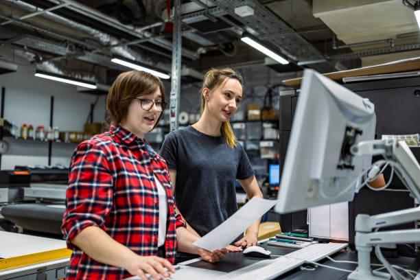 istock Professional female employees working in a printing house 2053194539