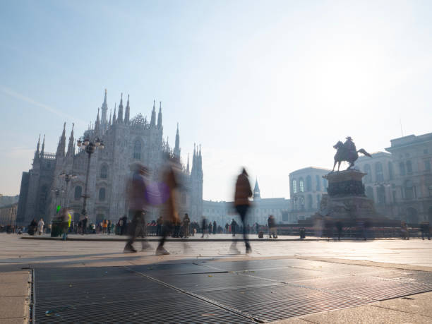 tourists walk in Piazza Duomo, Milan, Italy.