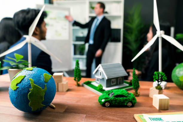 istock EV car model with mockup wind turbine on blurred background meeting. Quaint 2053202164