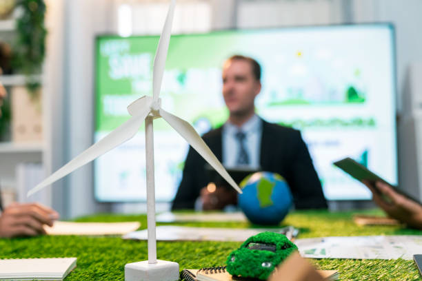istock EV car model with mockup wind turbine on blurred background meeting. Quaint 2053217486