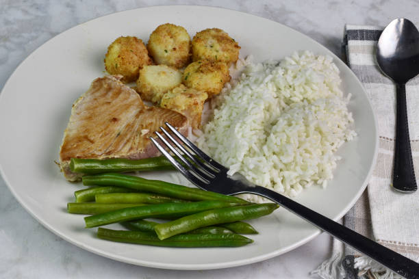 istock tuna steak served with scallops , rice and green beans, 2053257408