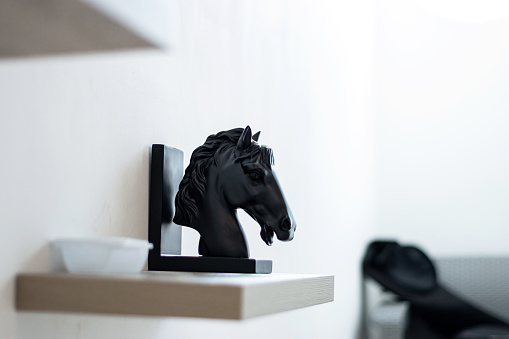 background photo of a decorative wooden horse figurine for a house or apartment in a close-up shot with shallow depth of field