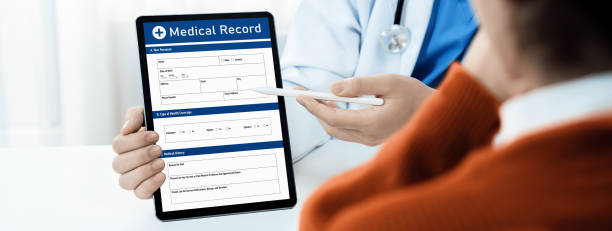 istock Laptop display medical report on blurred doctor office. Rigid 2053287384