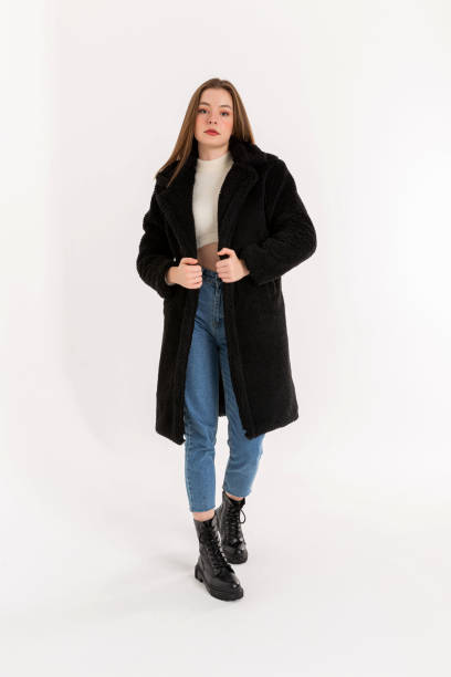 istock Brunette young woman wearing black coat. 2053287924