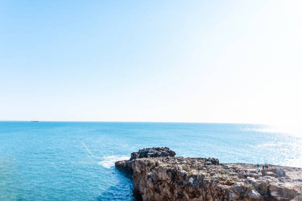 Beautiful blue ocean view with a cliff and a clear sunny horizon