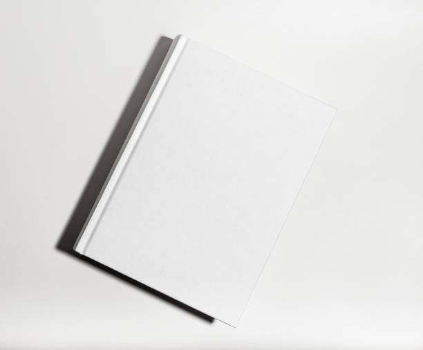 istock Blank book cover mockup. Clear textbook hardback, catalog lying on table 2053330079