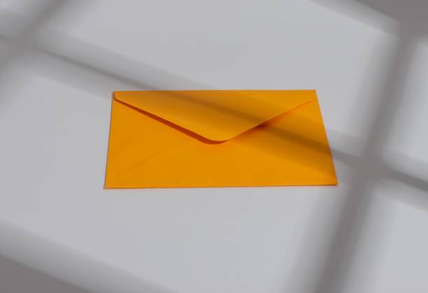 istock Orange paper envelope. Letter, mail, post, communication and correspondence concept 2053330615