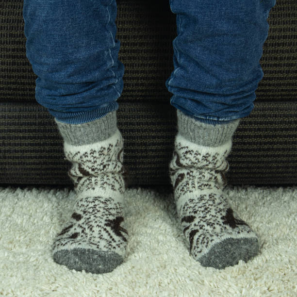 istock Men's feet in warm socks 2053338604