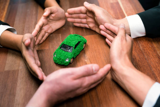 Business people synergy holding EV car model. Quaint