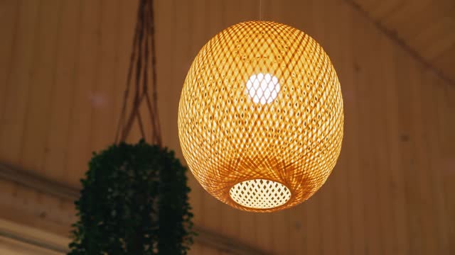 A beautiful lamp is hanging in the room, illuminating the room with warm light