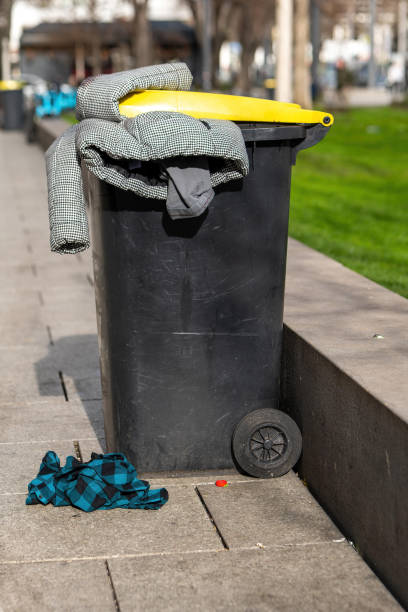 istock a waste garbage can with a yellow lid and a jacket 2053353505