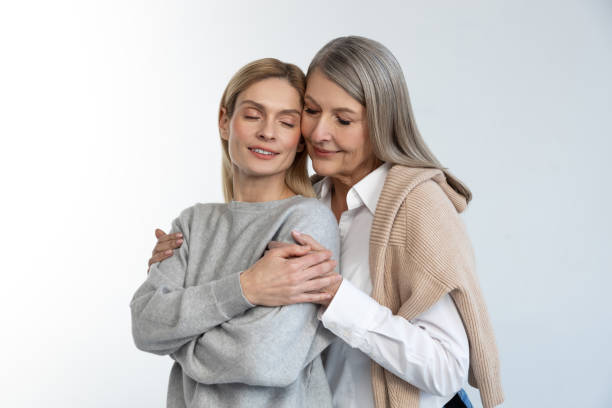 istock Mother and daughter hugging each other and looking peaceful 2053359921