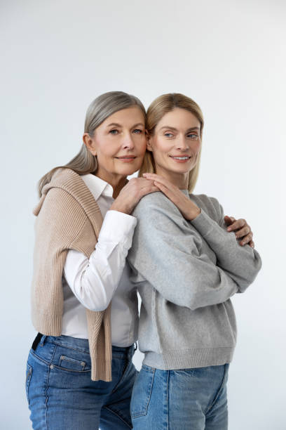 istock Mom and daughter standing close and looking peaceful 2053359952