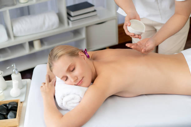 istock Masseuse prepare oil massage procedure for customer at spa. Quiescent 2053385382