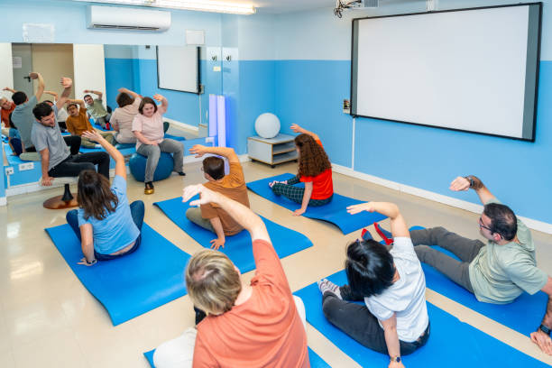 istock Disabled people stretching during yoga class together 2053412812