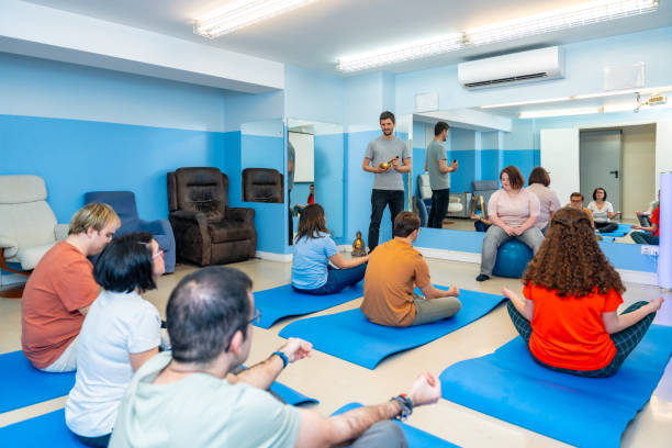 istock People with special needs in a yoga class 2053413847