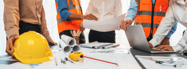 istock Engineer partner drawing and working on blueprint design together. Insight 2053414909