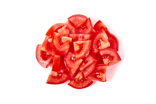 Heap of ripe chopped tomatoes isolated on white background. Top view