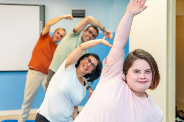 istock Group of people with special needs stretching in the gym 2053422886