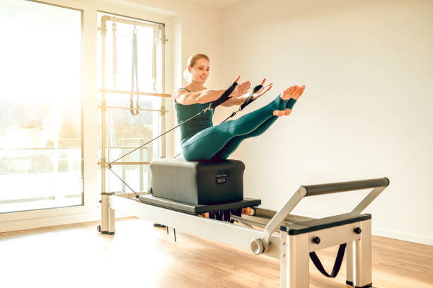 istock Woman has anaerobic workout session using Pilates machine in the gym 2053427419