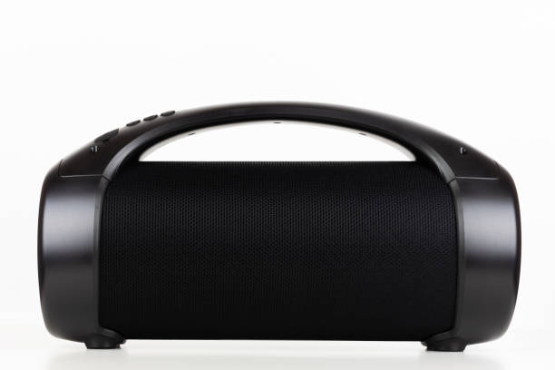 istock Black portable wireless speaker on the table close-up on a white background 2053429543