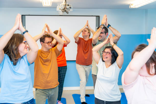 istock Disabled people having fun during yoga class together 2053430588