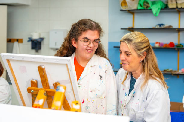 istock Disabled woman and teacher in a painting class 2053438112