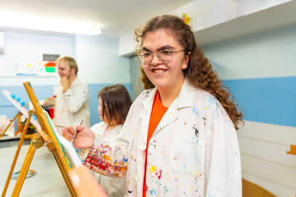 istock Disabled woman smiling during painting class indoors 2053446200