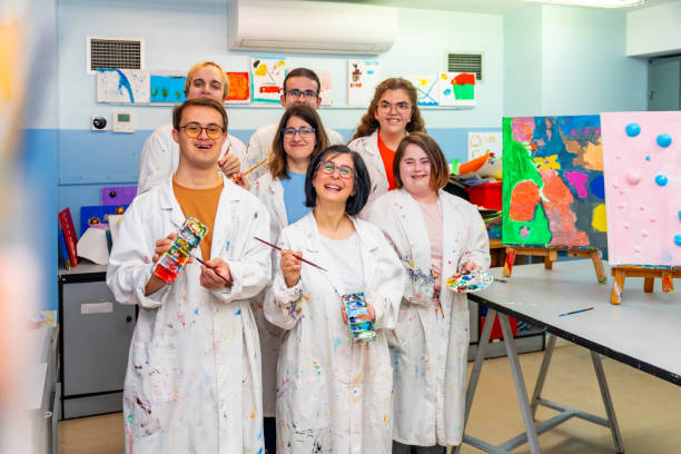 istock Class painting group with white coats with mental disabled people 2053446220