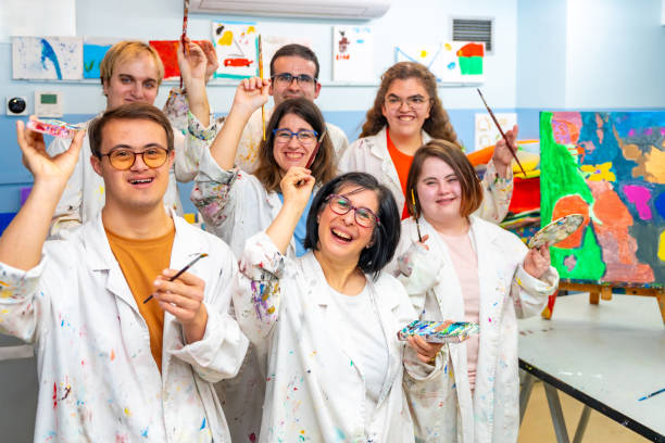 istock Happy disabled people with dirty coats in a painting class 2053447159
