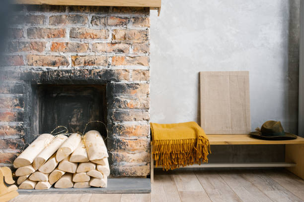 istock A fireplace with wood and a blanket on the bench next to it in a rustic Scandinavian style 2053448321