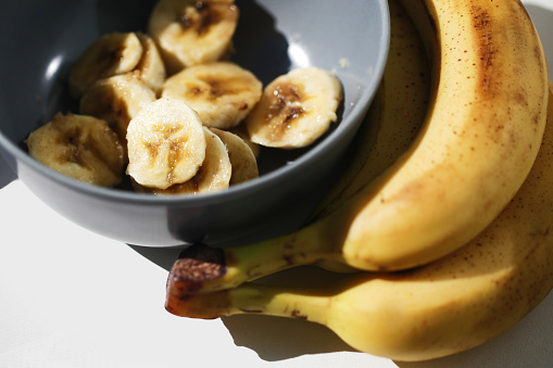 Food scraps use. Healthy smoothie preparation. Banana salad in bowl.