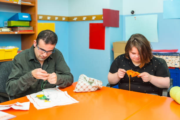 istock People with intellectual disabilities knitting clothes with wool 2053454688