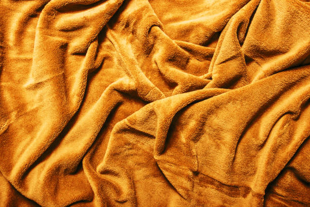 istock Yellow fabric background. Golden color blanket texture. Wave material pattern. Decorative curtain textile background. 2053455758