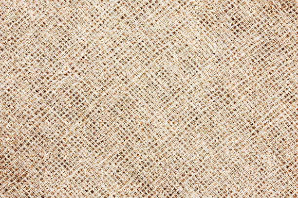 Hessian sackcloth woven jute burlap fabric cloth textile texture pattern background in brown beige aged color