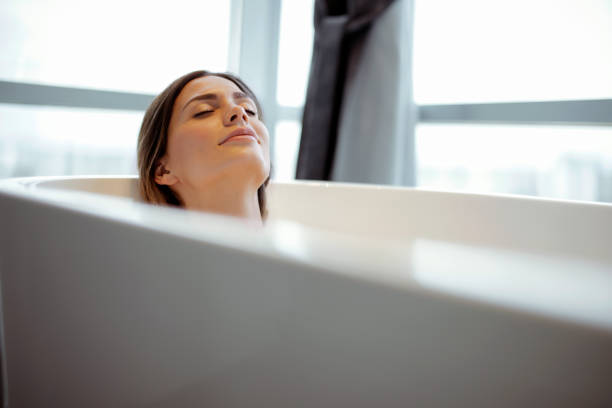 This is my happy place Relaxed young woman laying in bathtub woman hot shower stock pictures, royalty-free photos & images