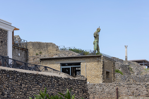 Pompeii, Naples, Italy - June 26, 2021: Statue by polish sculptor Igor Mitoraj among the riuns of ancient city destroyed by the eruption of the volcano Vesuvius in 79 AD