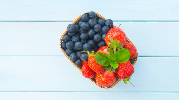 istock Basket with fresh strawberries and blueberries 2053538886