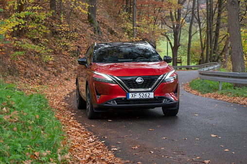 Zdiar, Slovakia - 25th October, 2022: Nissan Qashqai e-Power on a road in autumn scenery. This model is one of the most popular SUV vehicles in Europe.