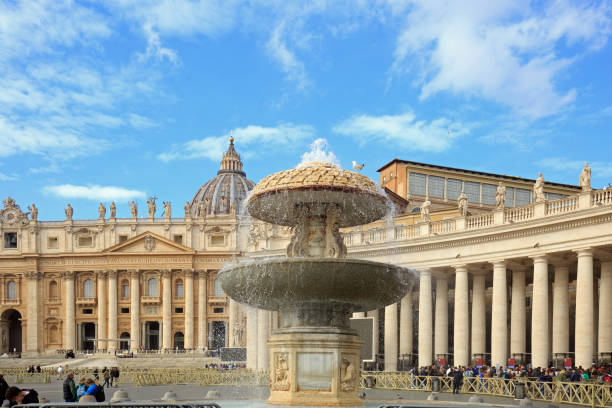 Vatican City, Vatican City State - March 11, 2023: Tourists gathering in st. Peter's square, admiring the splashing fountain and the stunning architecture of the basilica in Vatican city