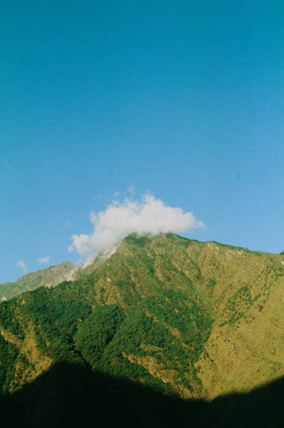 A small cloud caps the hilly mountain in dolakha nepal