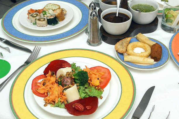 summer buffet, vegetable salad and sushi on a restaurant table, mixed salad