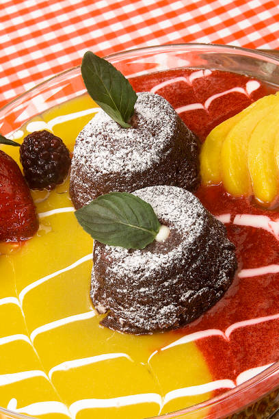 istock chocolate volcano dessert with mango and strawberry sauce on restaurant table 2053565087