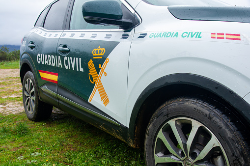 Badajoz, Spain. March 1, 2024. Side view of a Spanish Civil Guard patrol car parked in nature on a cloudy day.