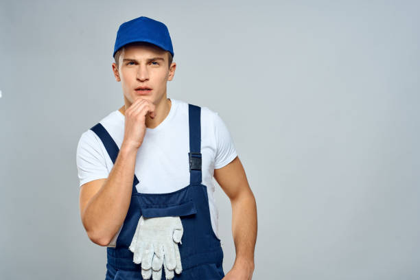 istock working man in uniform service lifestyle delivery service light background 2053650062