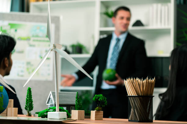 istock EV car model with mockup wind turbine on blurred background meeting. Quaint 2053677286