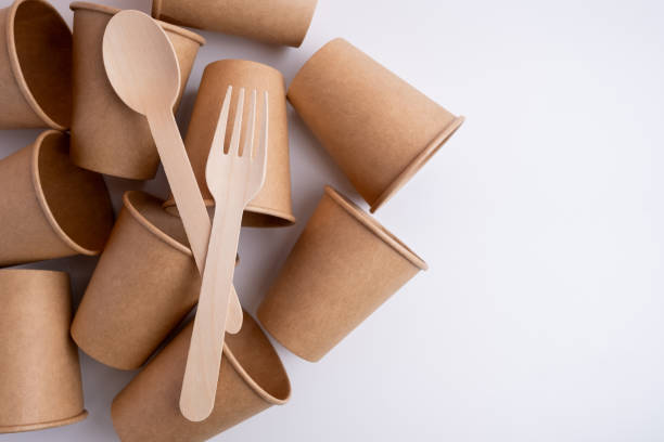 istock Kraft paper tableware: cups, food boxes, isolated on a light background. A set of various disposable tableware. Recycling and zero waste concept. Mock up 2053692329