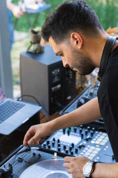 istock Sound engineer preparing the mixing console before starting the concert 2053693883