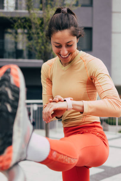 istock Active Woman Stretching Leg Outdoors Checking Fitness Tracker 2053694987